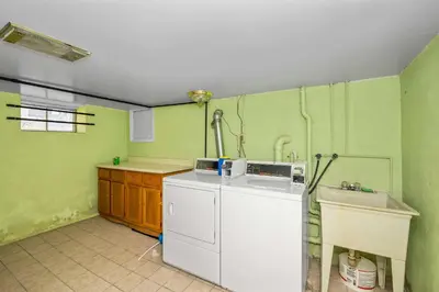 a kitchen with a washing machine and a sink at Northside Suites 3 - A Chic Relaxed Stay for 2 in Cincinnati