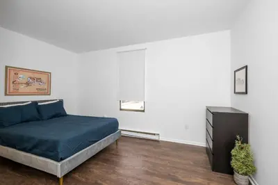 a bedroom with a bed and a dresser at Northside Suites 3 - A Chic Relaxed Stay for 2 in Cincinnati