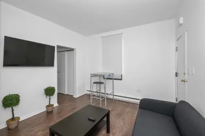 a living room with a couch and a table at Northside Suites 3 - A Chic Relaxed Stay for 2 in Cincinnati
