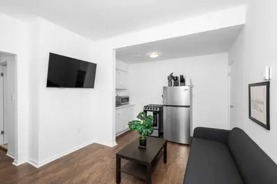 a living room with a couch and a refrigerator at Northside Suites 4 - Your Perfect Vacation Haven in Cincinnati