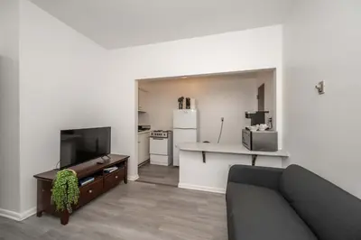 a living room with a couch and a kitchen at Northside Suites - 4 Apartments in Cincinnati
