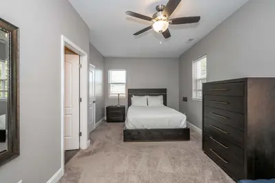 a bedroom with a bed and a ceiling fan at The Ruth House - Historic 4 BDR in Cincinnati