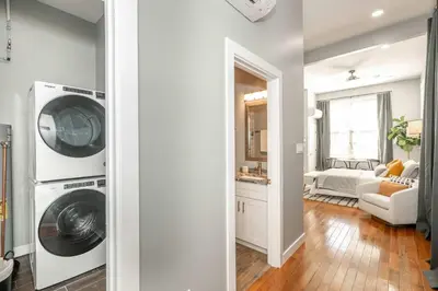 a living room with a washer and dryer in a house at Findlay Market Suite 1 - For 2 in Cincinnati