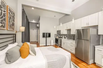 a kitchen with a large bed in a room at Findlay Market Suite 1 - For 2 in Cincinnati