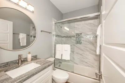 a bathroom with a shower and a toilet and a sink at Findlay Market Suite 2 - For 2 in Cincinnati