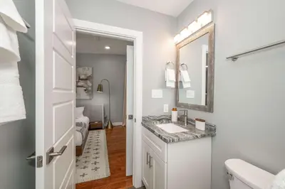 a bathroom with a sink and a mirror at Findlay Market Suite 6 - For 4 in Cincinnati