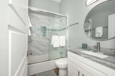 a bathroom with a toilet and a sink and a mirror at Findlay Market Suite 6 - For 4 in Cincinnati