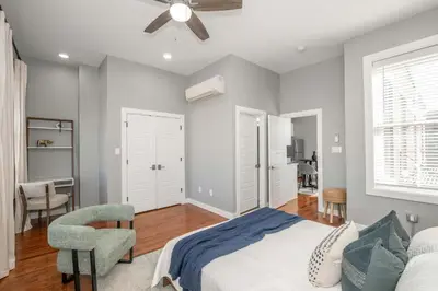 a bedroom with a bed and a chair at Findlay Market Suite 6 - For 4 in Cincinnati