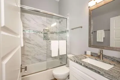 a bathroom with a shower and a toilet and a sink at Findlay Market Suites - 6 in 1 in Cincinnati