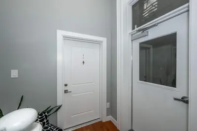 a hallway with a white door and a window at Findlay Market Suites - 6 in 1 in Cincinnati
