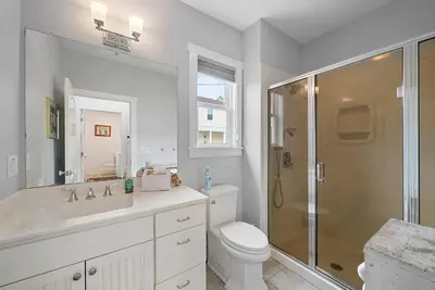 a bathroom with a shower and a toilet and a sink at Classic Charm on Ashland - For 8 in Columbus