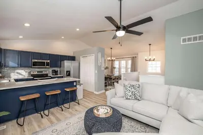 a living room with a white couch and a kitchen at Walton Arkside Oasis in Walton