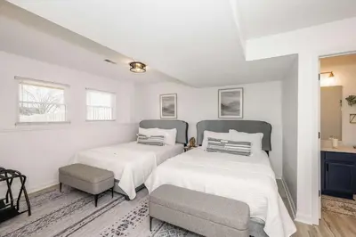 two beds in a room with white walls at Walton Arkside Oasis in Walton