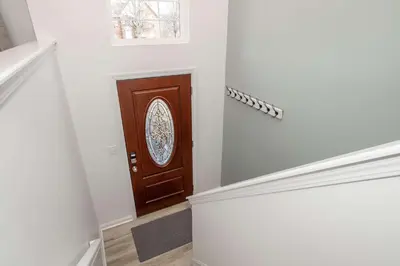 a hallway with a brown door with a window at Walton Arkside Oasis in Walton