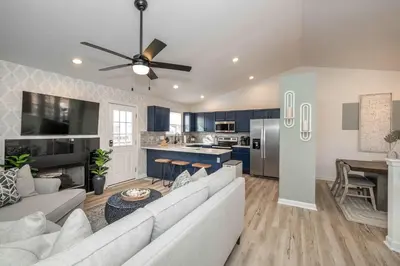 a living room with a white couch and a kitchen at Walton Arkside Oasis in Walton