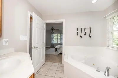 a white bathroom with a tub and a sink at Crittenden Ark Haven in Crittenden