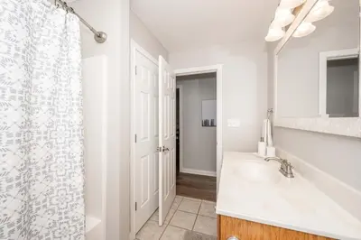 a white bathroom with a sink and a shower at Crittenden Ark Haven in Crittenden