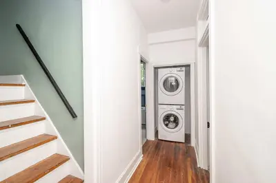 a hallway with a washer and dryer in a house at Woodburn Villa by Blackhouse in Cincinnati
