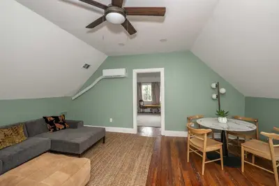 a living room with a couch and a ceiling fan at Woodburn Villa by Blackhouse in Cincinnati