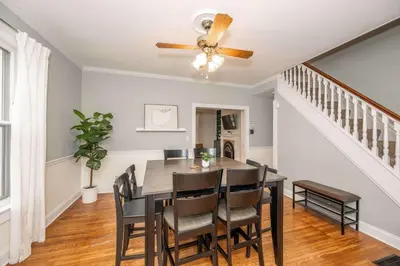 a dining room with a ceiling fan and a table and chairs at Clintonville Charm in Columbus