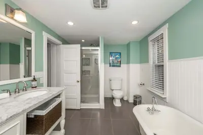 a bathroom with two sinks and a tub and a toilet at Clintonville Charm in Columbus