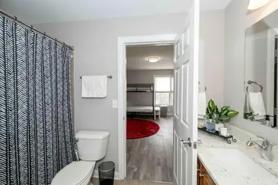 a white bathroom with a toilet and a sink at Mason Oasis 5 BDR Home Sweet Home Family-Friendly in Mason