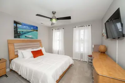 a bedroom with a bed and a flat screen tv at Mason Oasis 5 BDR Home Sweet Home Family-Friendly in Mason