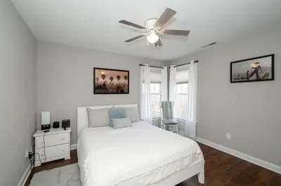 a white bedroom with a bed and a ceiling fan at Mason Oasis 5 BDR Home Sweet Home Family-Friendly in Mason