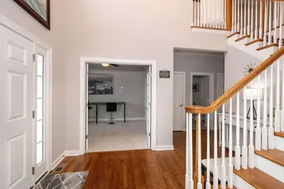 an open hallway with a stairway leading into a home office at Mason Oasis 5 BDR Home Sweet Home Family-Friendly in Mason