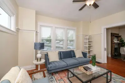 a living room with a blue couch and a table at The Cincinnati Cottage in Cincinnati