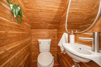 a bathroom with a toilet and a sink at The Cincinnati Cottage in Cincinnati