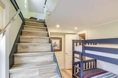 a staircase in a tiny house with bunk beds at 1 Block to Beach Home with Hot Tub in Port Clinton! in Port Clinton