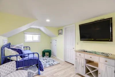 a bedroom with a bed and a flat screen tv at 1 Block to Beach Home with Hot Tub in Port Clinton! in Port Clinton