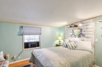 a bedroom with a bed and a window at 1 Block to Beach Home with Hot Tub in Port Clinton! in Port Clinton