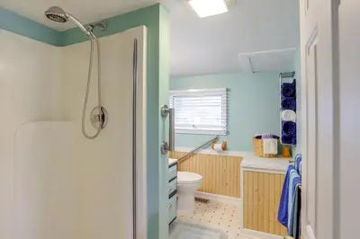 a bathroom with a shower and a toilet at 1 Block to Beach Home with Hot Tub in Port Clinton! in Port Clinton