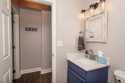 a bathroom with a sink and a mirror at Heart of Mainstrasse 1 in Covington