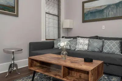 a living room with a couch and a coffee table at Heart of Mainstrasse 2 in Covington