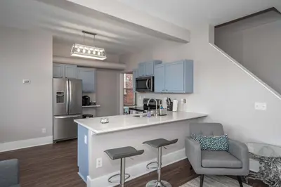 a kitchen with a counter and two chairs and a counter top at Heart of Mainstrasse 4 in Covington