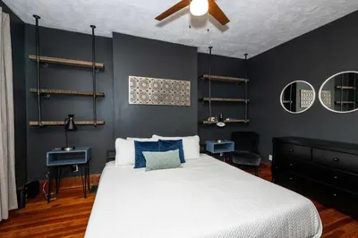a bedroom with a bed and a ceiling fan at Historic Retreat Gateway in Dayton