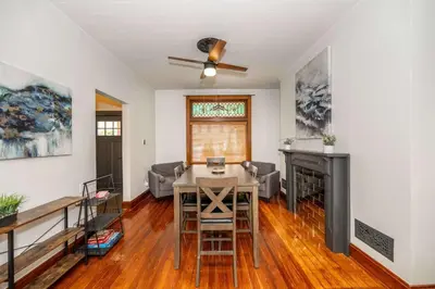 a living room with a table and a fireplace at Historic Retreat Gateway in Dayton