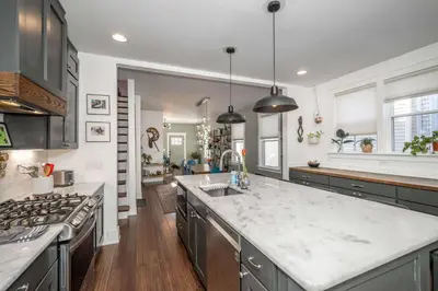 a large kitchen with a sink and a stove at Northside Nook Home for 6 in Cincinnati