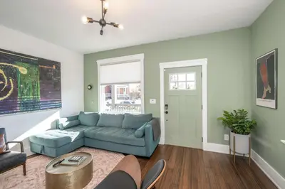 a living room with a blue couch and a table at Northside Nook Home for 6 in Cincinnati