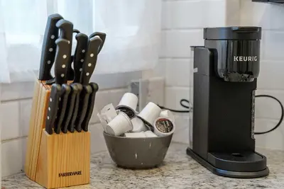 a kitchen counter with a knife block and a coffee maker at Urban Elegance Getaway in Columbus