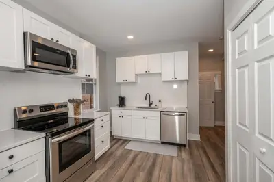 a kitchen with white cabinets and stainless steel appliances at The LUXE Spot 1 in Covington