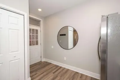a hallway with a mirror on a white wall at The LUXE Spot 1 in Covington