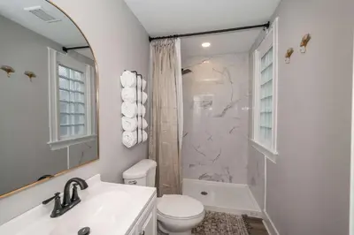 a bathroom with a sink and a toilet and a shower at LUXE Spot 2 in Covington
