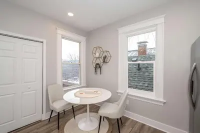 a white room with a table and chairs and a window at LUXE Spot 2 in Covington