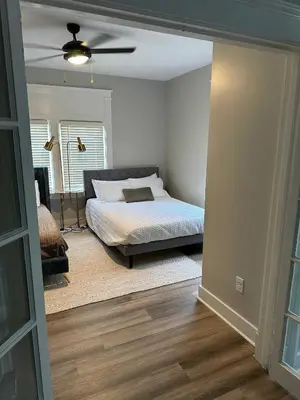 a bedroom with a bed and a ceiling fan at LUXE Spot Suites in Covington