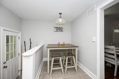 a small kitchen with a table and two stools at Hunley Haven Retreat in Cincinnati