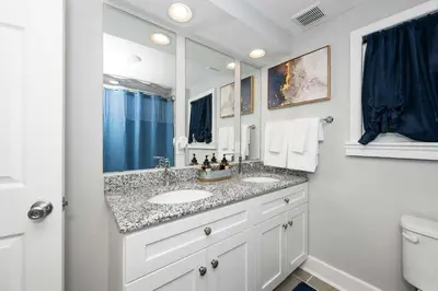 a bathroom with two sinks and a large mirror at Hunley Haven Retreat in Cincinnati
